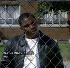 a man standing behind a chain link fence with the words making money is me on it