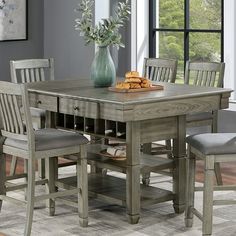 a dining room table with chairs around it