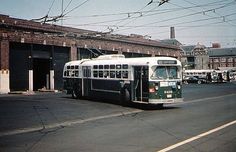 an old bus is driving down the street