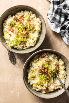 two bowls filled with rice and vegetables on top of a table