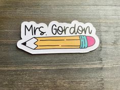 a sticker that says mrs gordon with a pencil sticking out of the back of it