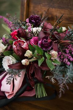 a bouquet of flowers sitting on top of a wooden table