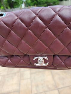 This CHANEL Classic Flap shoulder bag is a must-have for any fashion-conscious woman. The bordeaux red color of the exterior is complemented by the silver hardware and turn lock closure. The bag is made of high-quality leather and features an argyle/diamond pattern that adds a touch of sophistication to any outfit. Inside, the bag is lined with satin and lambskin in a stylish gray color. The small size of the bag makes it perfect for everyday use, and it comes with original accessories, includin Chanel Maxi, Argyle Diamonds, Classic Flap Bag, Flap Shoulder Bag, Classic Flap, Flap Bag, Diamond Pattern, Silver Hardware, High Quality Leather