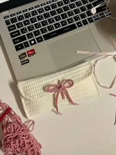 an open laptop computer sitting on top of a desk next to a pair of scissors