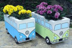 two planters made out of cardboard with flowers in them