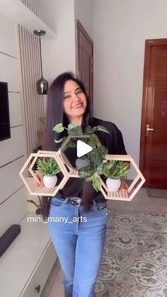 a woman is holding some plants in her hands