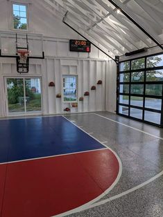 an indoor basketball court is painted red, white and blue