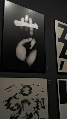 several black and white pictures hanging on the wall