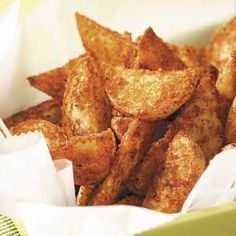 some fried food is in a basket with napkins and a fork on the side