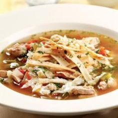 a white bowl filled with chicken and vegetable soup