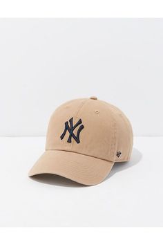 a new york yankees baseball cap with the ny logo on it in tan and black