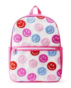 Carry a smile wherever you go thanks to this adorable backpack! Designed in the perfect size to hold your essentials and featuring colorful smiley faces, this backpack is the perfect accessory for school, work, or travel. Complete with side pockets, a laptop sleeve, a front pocket, and ample storage space, this backpack is truly ready to bring on the fun! Knit standard size backpack with smiley face design Laptop sleeve Front pocket & 2 exterior water bottle pockets Adjustable shoulder straps Dimensions: 12"W x 6"D x 17"H Knit jacquard fabric 2 exterior pink pockets for a water bottle Pink nylon adjustable straps & top handle Front zipper pocket Laptop sleeve CARE: Spot clean with a damp white cloth Fun Travel Backpack With Zipper Closure, Playful School Backpack With Zipper Closure, Playful School Backpack With Zipper, Fun School Bags With Zipper Closure, Fun Backpack For Everyday Use And Back To School, Fun Travel Backpack For Back To School, Playful White Student Backpack, Playful Pink Backpack For Everyday Use, Playful Backpack For Daily Use