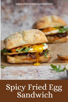 two grilled egg sandwiches sitting on top of a cutting board