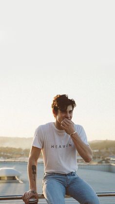 a young man sitting on top of a skateboard