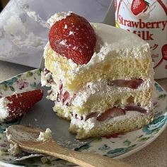 a piece of cake on a plate with strawberries