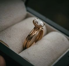 a close up of a ring in a box