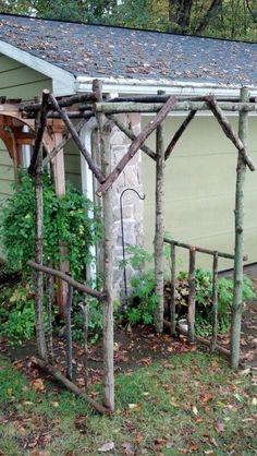 an old garden trellis is being used as a planter in front of a house