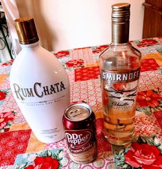 two bottles of rumchata and a can of soda on a quilted tablecloth