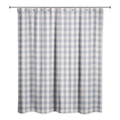 a blue and white checkered shower curtain hanging from a metal rod on a wall