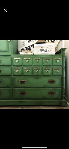 an old green dresser with many drawers