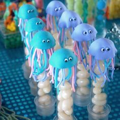 there are many jellyfish in the cupcakes with eyes on them and one is blue