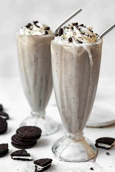 two glasses filled with ice cream and oreo cookies