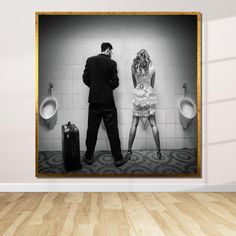 a man and woman standing next to urinals in a bathroom