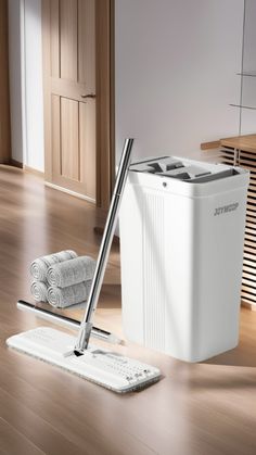 a white cooler sitting on top of a hard wood floor next to a towel rack