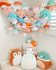 a bunch of stuffed animals hanging from the ceiling