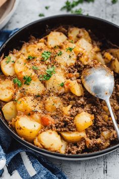 a skillet filled with potatoes and ground beef