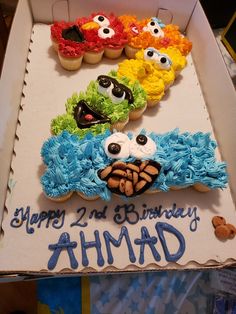 a birthday cake with cupcakes in the shape of sesame street characters on it