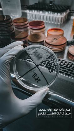 a person in white gloves holding up a magnifying glass with words on it