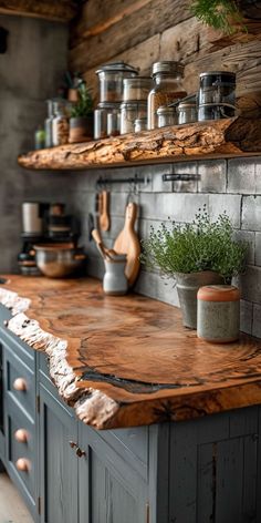 the kitchen counter is made out of wood and has potted plants on top of it