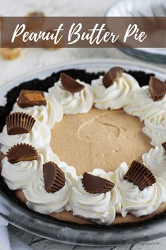 a peanut butter pie with white frosting and chocolate chips on top, sitting on a table