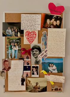 a bulletin board covered in pictures and magnets with hearts attached to the back wall