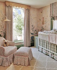 a baby's room with floral wallpaper and furniture