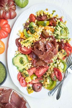 a white plate topped with vegetables and meat