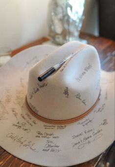 a white hat with writing on it sitting on top of a table