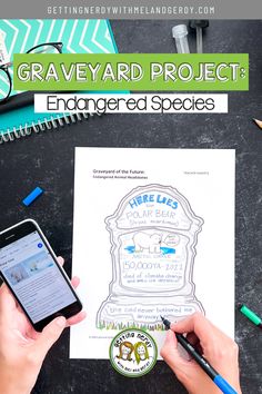 two hands holding a cell phone over a paper with the words graveyard project on it