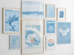 there are many pictures on the wall with blue and white designs in them, including an ocean wave