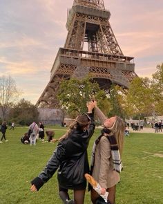 two women standing in front of the eiffel tower