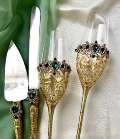 three gold colored utensils are next to each other