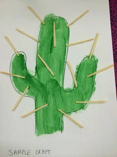 a drawing of a green cactus with sticks sticking out of it