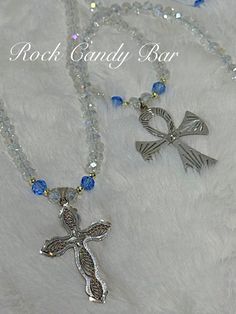 We have lotsa passion for religious jewelry and use vintage sterling silver crosses on our crystal cross necklaces. Each of our vintage crosses is a unique and treasured find.  The two particular crosses in this listing are both sterling silver.  We hand strung a beautiful bright and sparkly everyday clear crystal chain which is not too chunky and definitely not tiny.  The crystals sparkle many different colors with the change of light.  We add pretty blue crystals into the mix on each side of our vintage sterling crosses. We tie them on matching light blue cord and use a silver-toned recycled toggle clasp.  If you haven't read our story, we love using unique, sustainable items in our pieces. These beautiful cross necklaces look great on and make wonderful gifts! Each of our unique crystal Chunky Crystal Necklace, Crystal Cross, Crystal Chain, Handmade Christmas Gifts, Sterling Silver Cross, Religious Jewelry, Silver Cross, Religious Gifts, Blue Crystals