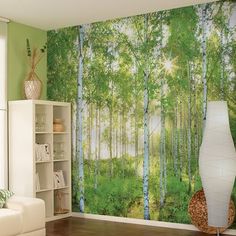 a living room with a large mural on the wall next to a white couch and coffee table