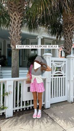 a woman leaning on a white fence with palm trees in the background and text overlay that reads easy picture / pose ideas