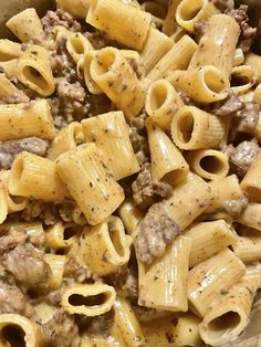 a bowl full of pasta with meat and sauce