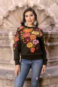 Introducing our exquisite Mexican Floral Embroidered Crew Neck, a wearable work of art crafted with precision on artisanal machines. This vibrant and intricately embroidered piece seamlessly blends traditional Mexican craftsmanship with modern style. Each delicate petal and intricate detail is brought to life through skillful embroidery, showcasing the rich heritage of Mexican artistry.  The crew neck's soft fabric ensures comfort, while the floral motif adds a touch of elegance and cultural fla Multicolor Folk Top For Fall, Embroidered Crew Neck Blouse, Crew Neck Blouse With Floral Embroidery, Folk Tops With Embroidered Sleeves For Fall, Fall Embroidered Crew Neck Top, Traditional Tops With Embroidered Sleeves For Fall, Folk Style Floral Embroidery Top For Fall, Bohemian Long Sleeve Embroidered Sweater, Multicolor Embroidered Long Sleeve Top For Fall