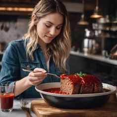 a woman sitting at a table with a plate of meatloaf in front of her