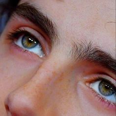 a close up of a person with blue eyes